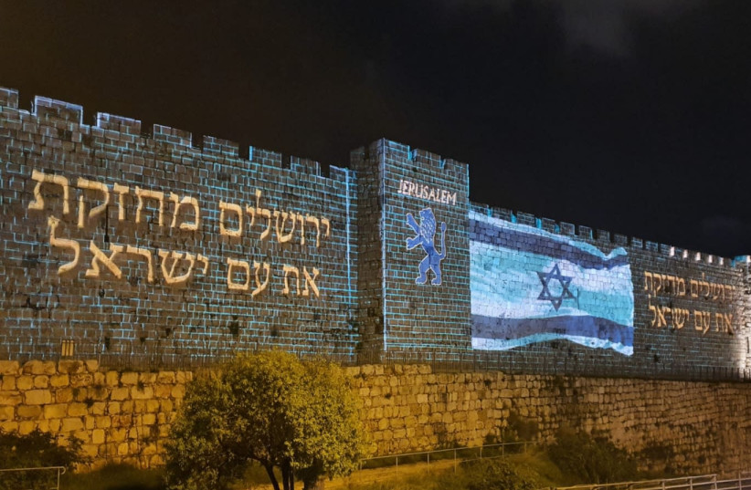 Jerusalem shows support to the entire people of Israel with the flag displayed on the Old City Walls on Thursday March 19 2020  (credit: ARNON BOSSANI)