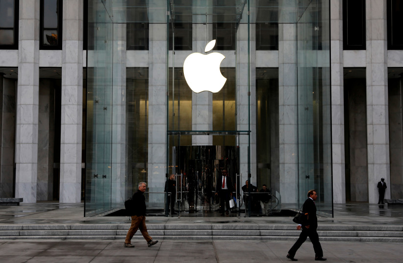 FILE PHOTO: The Apple Inc. logo is seen hanging at the entrance to the Apple store on 5th Avenue in Manhattan, New York, U.S., October 16, 2019 (credit: REUTERS/MIKE SEGAR/FILE PHOTO)
