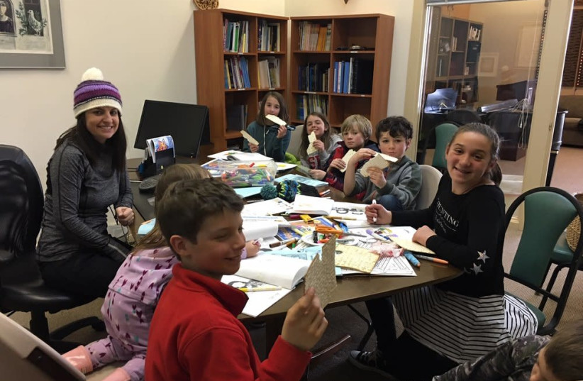 Setting the stage for Passover with matzah at the Wood River Jewish Community's Hebrew school (credit: COURTESY OF THE WOOD RIVER JEWISH COMMUNITY)
