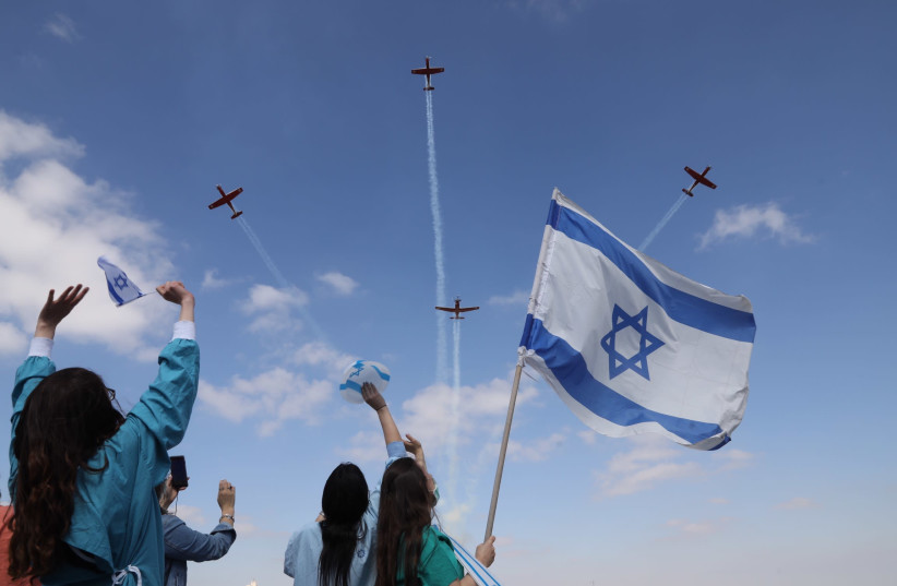 Medical staff at Jerusalem’s Shaare Zedek Medical Center wave at an Israel Air Force flyover on Independence Day (credit: MARC ISRAEL SELLEM)