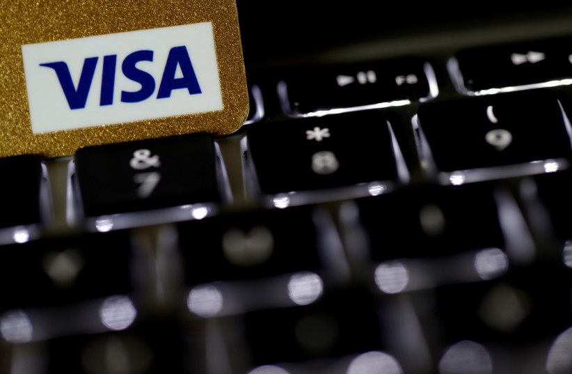 A Visa credit card is seen on a computer keyboard in this picture illustration (credit: REUTERS/PHILIPPE WOJAZER)