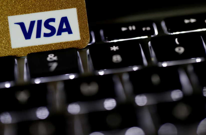 A Visa credit card is seen on a computer keyboard in this picture illustration