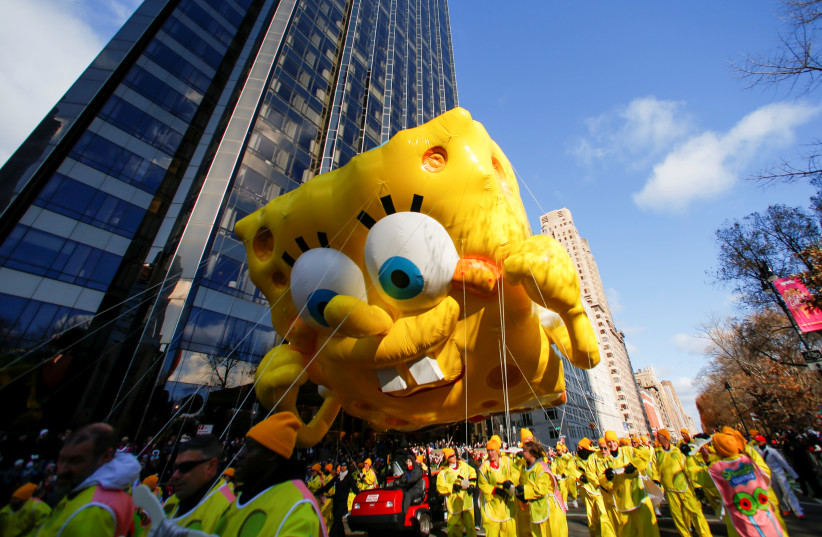 The Spongebob SquarePants with Gary the Snail balloon hovers above the crowd during the 93rd Macy's Thanksgiving Day Parade in New York, U.S., November 28, 2019. (credit: CAITLIN OCHS/REUTERS)