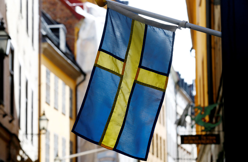 The Swedish flag is seen at Gamla Stan, the Old City of Stockholm, Sweden, May 7, 2017. (credit: INTS KALNINS / REUTERS)