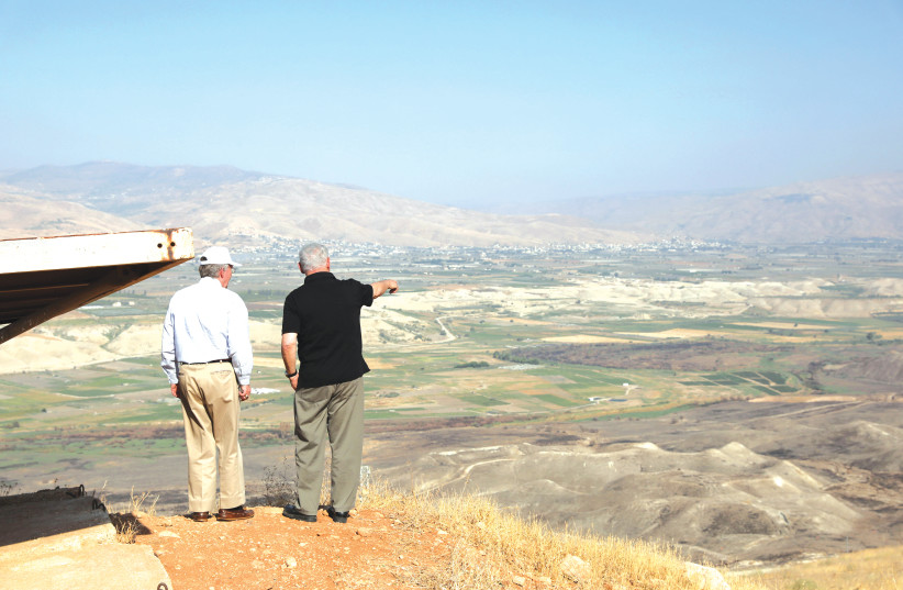 Prime Minister Benjamin Netanyahu visits an old army outpost overlooking the Jordan Valley last June.  (credit: ABIR SULTAN / REUTERS)