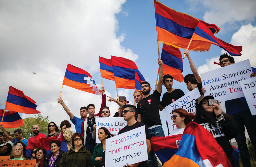 MEMBERS OF THE Armenian community of Jerusalem hold signs and Armenian flags as they protest in front of the Foreign Ministry against Israel’s weapon sales to Azerbaijan in 2016. (photo credit: CORINNA KERN/FLASH90)