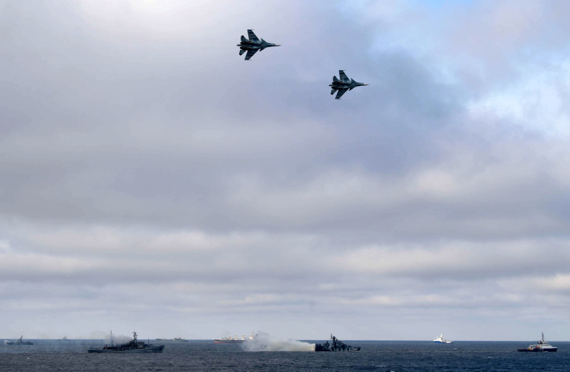 Russian Navy's ships and jet fighters are seen during the joint drills of the Northern and Black Sea fleets, attended by Russian President Vladimir Putin, in the Black Sea, off the coast of Crimea January 9, 2020 (photo credit: SPUTNIK/ALEXEI DRUZHININ/KREMLIN VIA REUTERS)