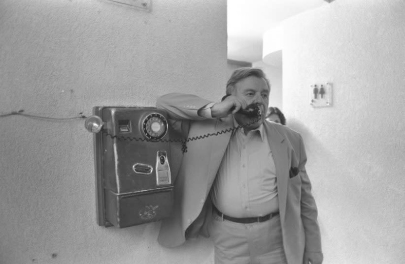The late Teddy Kollek, mythical Mayor of Jerusalem, talks on a public phone (photo credit: NATI HARNIK/GPO)
