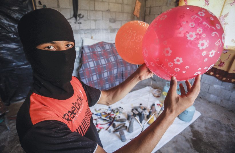 PALESTINIANS IN Rafah earlier this month prepare balloons attached with flammable materials to be released into Israel. (photo credit: ABED RAHIM KHATIB/FLASH90)