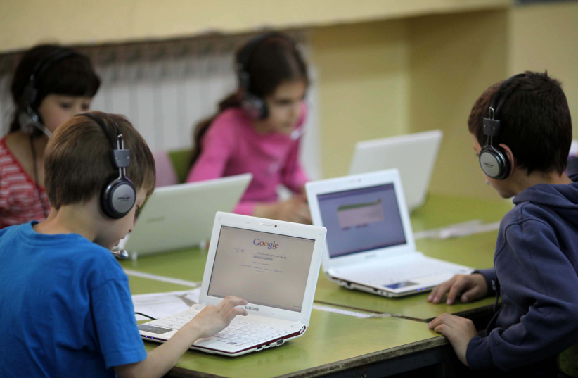 Israeli children in second grade (7 - 8 years old) using computers in a class room during a lesson at the "Janusz Korczak" school  in Jerusalem. May 17, 2011. (photo credit: KOBI GIDEON/FLASH90)
