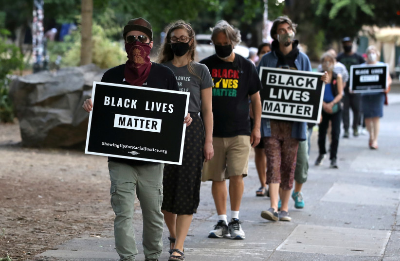 People participate in a meditation walk in support of Black Lives Matter organized by the Portland Buddhist Peace Fellowship near the Justice Center in Portland, Oregon, U.S., September 1, 2020. (credit: CAITLIN OCHS/REUTERS)