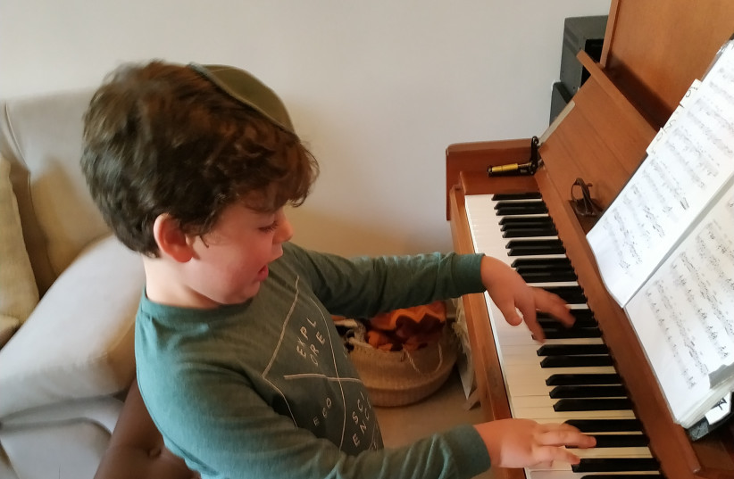 Schertzman’s grandson, Eli Schertzman, playing the piano in Efrat (photo credit: Courtesy)