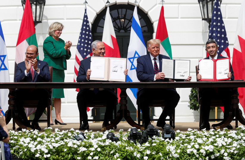 L to R: Bahrain’s Foreign Minister Abdullatif Al Zayani, Israel's Prime Minister Benjamin Netanyahu, US President Donald Trump and United Arab Emirates (UAE) Foreign Minister Abdullah bin Zayed participate in the signing of the Abraham Accords. September 15, 2020 (credit: REUTERS/TOM BRENNER)