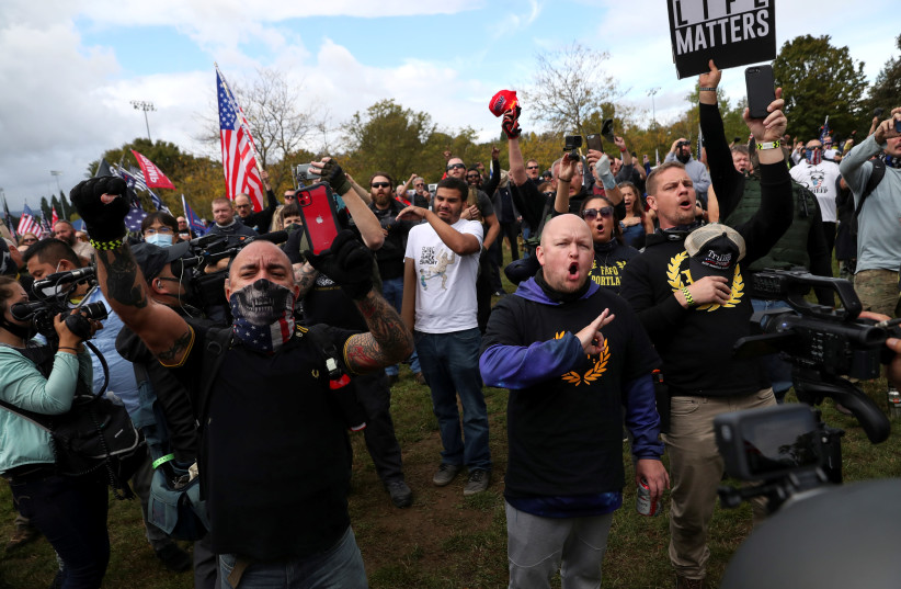 People gesture and shout slogans during a rally of the far right group Proud Boys, in Portland (photo credit: REUTERS)