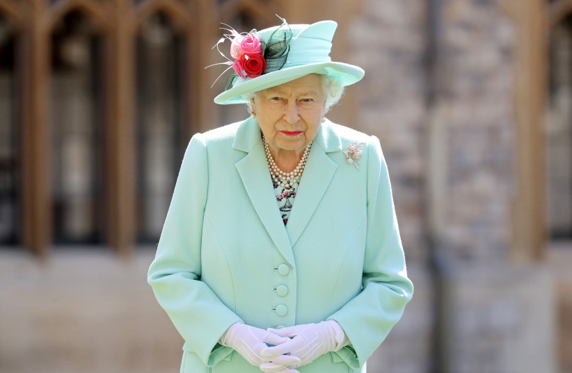 Britain's Queen Elizabeth poses after awarding Captain Tom Moore with the insignia of Knight Bachelor at Windsor Castle, in Windsor, Britain July 17, 2020. (credit: REUTERS/CHRIS JACKSON)