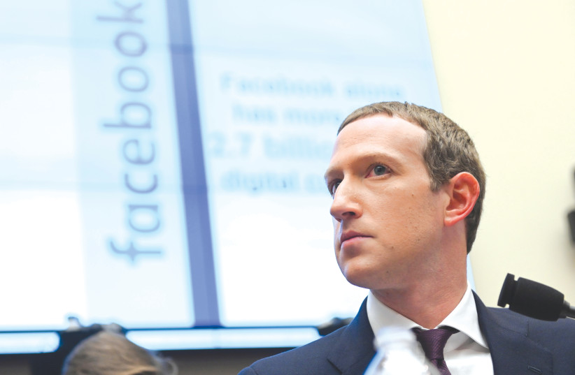 It took time, but Facebook CEO Mark Zuckerberg should be commended for banning content that denies and distorts the Holocaust.  (photo credit: ERIN SCOTT/REUTERS)