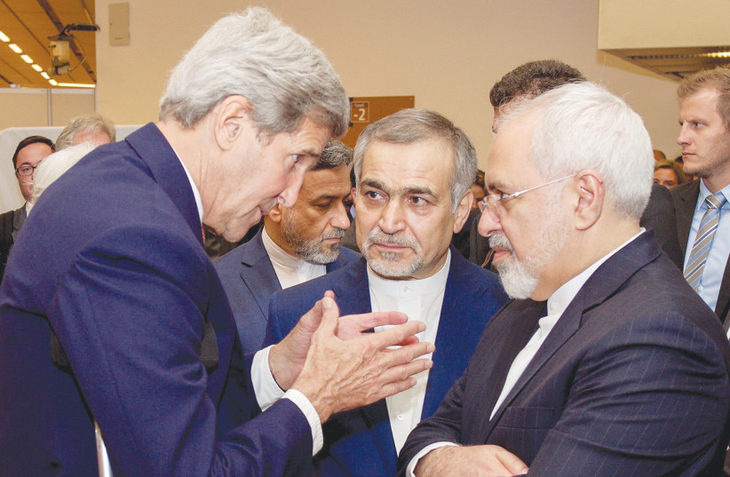 FORMER US secretary of state John Kerry speaks to Iranian Foreign Minister Javad Zarif as Hossein Fereydoun, the brother of Iranian President Hassan Rouhani, looks on in Vienna, Austria, July 14, 2015. (photo credit: US STATE DEPARTMENT/ REUTERS)