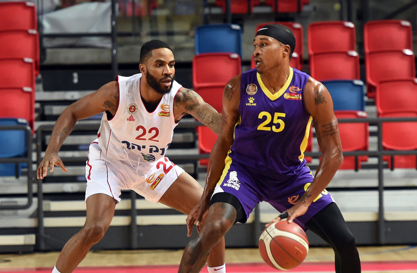 TYRUS MCGEE (right) scored a game-high 27 points to lead Hapoel Holon to an 89-85 victory over Tarik Phillip (left) and Hapoel Jerusalem in Saturday night's Winner Cup semifinal tilt.  (credit: BERNEY ARDOV)