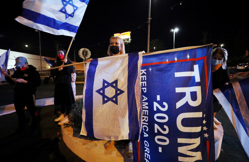 US President Donald Trump supporters take part in a rally ahead of the US presidential election day in Beit Shemesh, Israel November 2, 2020 (credit: AMMAR AWAD/REUTERS)