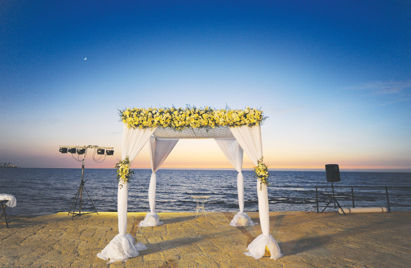 An illustrative photo of a Jewish wedding in front of the Mediterranean Sea. (credit: MENDY HECHTMAN/FLASH90)