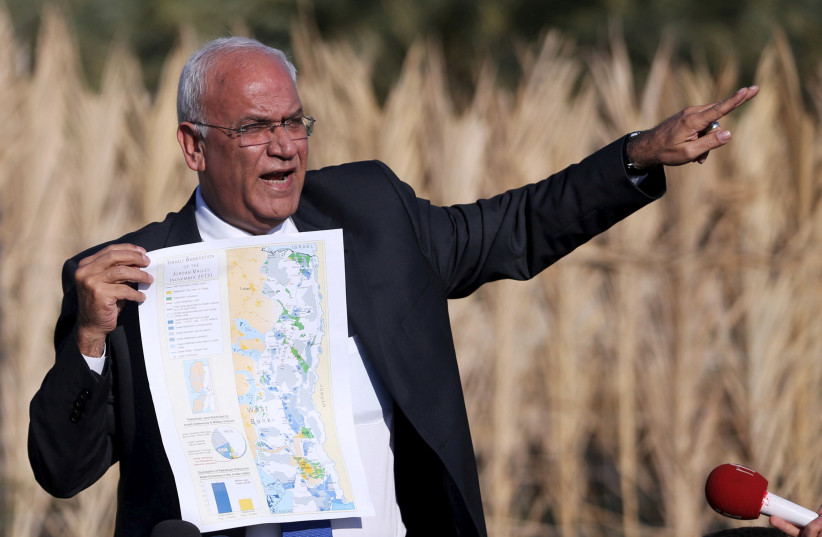 Palestinian Chief negotiator Saeb Erekat holds a map as he speaks to media about the Israeli plan to appropriate land, in Jordan Valley near the West Bank city of Jericho, January 20, 2016 (credit: REUTERS/MOHAMAD TOROKMAN/FILE PHOTO)