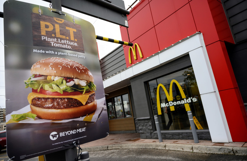 A sign promoting McDonald's ''PLT'' burger with a Beyond Meat plant-based patty at one of 28 test restaurant locations in London, Ontario (credit: REUTERS)