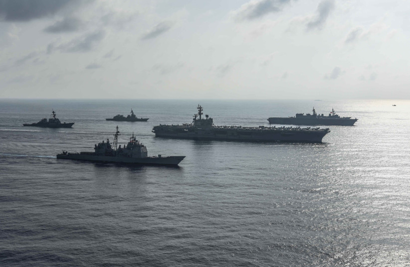 The US Navy aircraft carriers conduct a photo exercise with the Japan Maritime Self-Defense Forces in the South China Sea August 31, 2018 (credit: MASS COMMUNICATION SPECIALIST 2ND CLASS KAILA V. PETER/U.S. NAVY/HANDOUT VIA REUTERS)