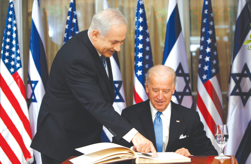 PRIME MINISTER Benjamin Netanyahu shows then-vice president Joe Biden where to sign the guest book, at the Prime Minister’s Residence in Jerusalem in 2010. (credit: RONEN ZVULUN/REUTERS)