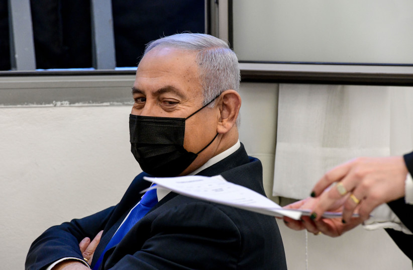 Israeli prime minister Benjamin Netanyahu seen as he arrives for a court hearing at the District Court in Jerusalem on February 8, 2021, PM Netanyahu is on trial on criminal allegations of bribery, fraud and breach of trust. (credit: REUVEN KASTRO/POOL)