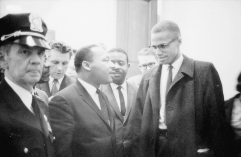 Martin Luther King Jr. and Malcolm X wait for a press conference to begin in an unknown location, March 26, 1964 (credit: CONGRESS/MARION S. TRIKOSKO/HANDOUT VIA REUTERS)