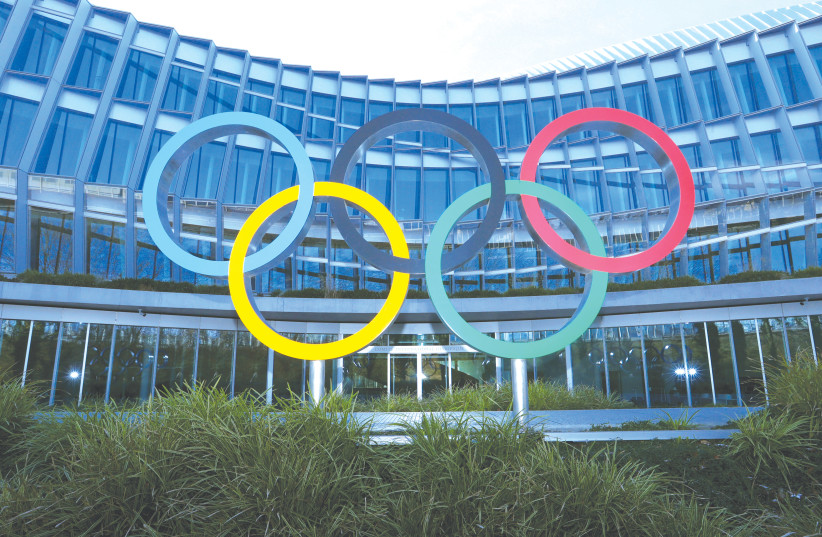 THE OLYMPIC rings are pictured in front of the International Olympic Committee (IOC) headquarters during the coronavirus disease (COVID-19) outbreak in Lausanne, Switzerland last month. (photo credit: DENIS BALIBOUSE/REUTERS)