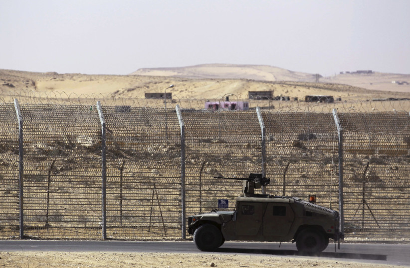 Armoured Israeli military vehicle driving along border with Egypt (credit: AMIR COHEN/REUTERS)