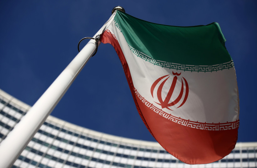 The Iranian flag waves in front of the International Atomic Energy Agency (IAEA) headquarters, before the beginning of a board of governors meeting, amid the coronavirus disease (COVID-19) outbreak in Vienna, Austria, March 1, 2021. (credit: REUTERS/LISI NIESNER)