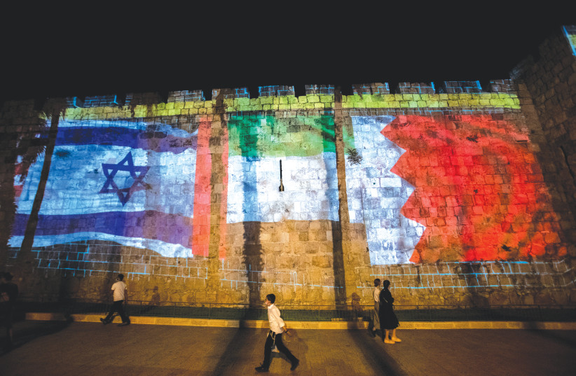 THE FLAGS of the US, UAE, Israel and Bahrain are projected on the walls of Jerusalem’s Old City in September. (photo credit: YONATAN SINDEL/FLASH90)
