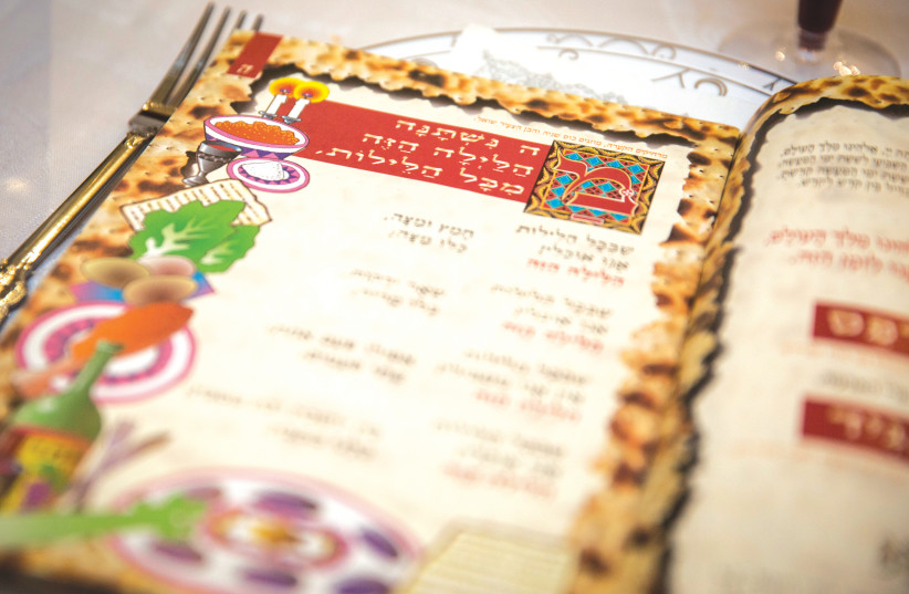 THE HAGGADAH is read during a Passover Seder. (credit: HADAS PARUSH/FLASH90)