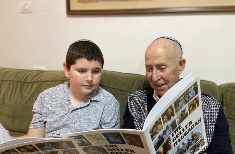ALL IN the family: The writer reviews the  Haggadah with a grandchild. (credit: COURTESY STUART GELLER)