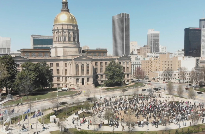 People participate in a Stop Asian Hate rally at Liberty Plaza, next to the Georgia State Capitol, in Atlanta, Georgia, March 20, 2021, in this still image from drone video obtained via social media. (credit: ARRHYTHMIA FILMS VIA REUTERS)