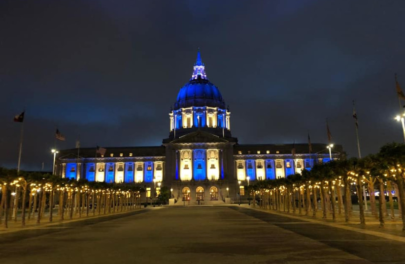 The San Francisco City Hall is seen lit up in blue and white. (photo credit: SHANIE ROTH)