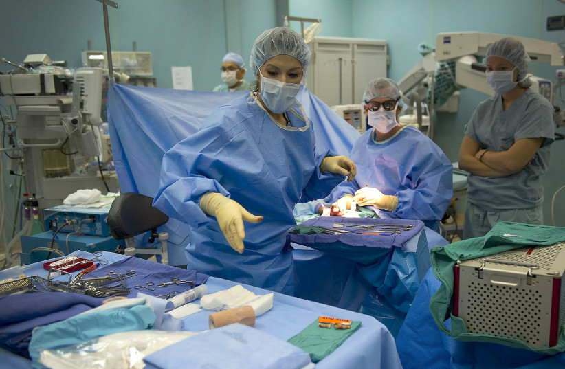 Plastic surgery procedure being performed in an operating room. (photo credit: Courtesy)