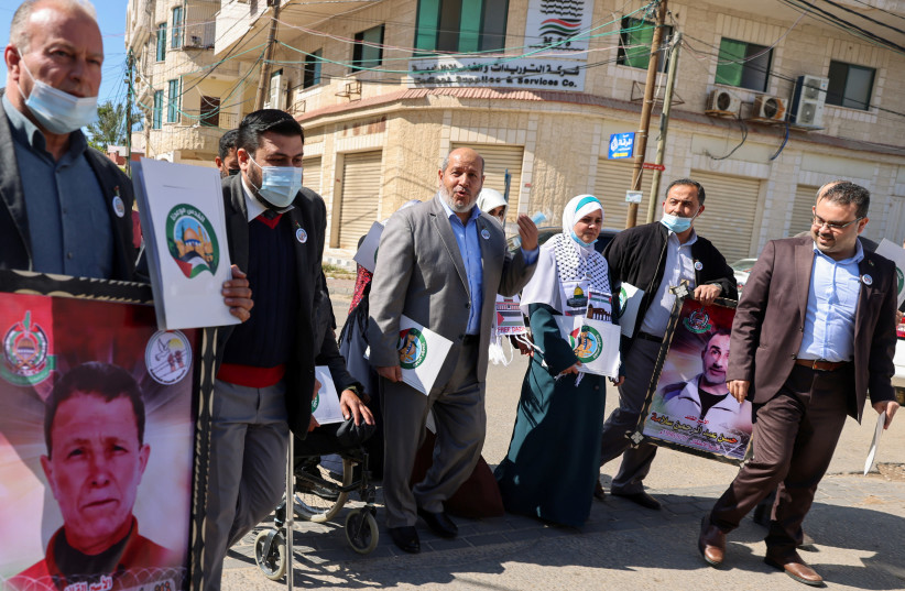 Khalil al-Hayya, Hamas's deputy leader in Gaza, arrives with other representatives to register Hamas's list for the upcoming parliamentary elections, in Gaza City March 29, 2021. Picture taken March 29, 2021. (photo credit: REUTERS/MOHAMMED SALEM)