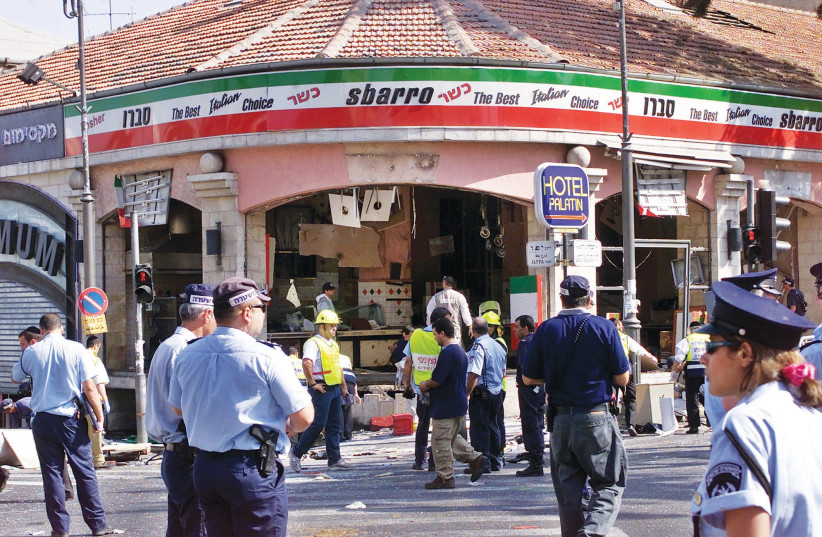 A GAPING hole is left in the shop front of the Sbarro pizzeria in Jerusalem after the suicide bombing that killed 15 people and wounded more than 80 others. (credit: REUTERS)