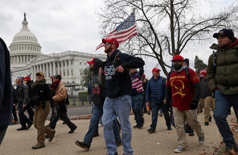 Members of the Proud Boys and supporters of US President Donald Trump show up at the US Capitol Building over an hour before supporters began to storm the building in Washington, US, January 6, 2021. (photo credit: REUTERS/LEAH MILLIS)