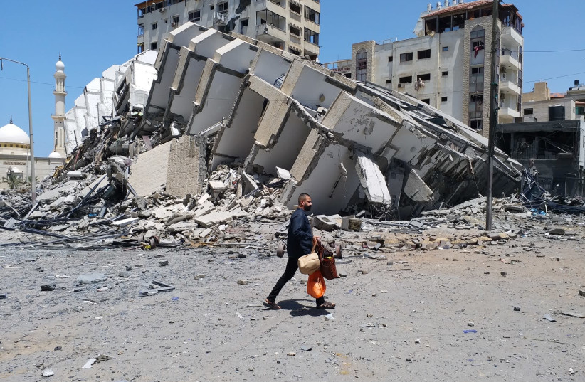 A Palestinian man walks amid the destruction in central Gaza City, May 12, 2021.