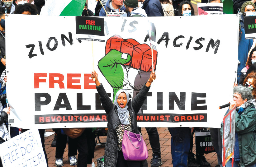 PRO-PALESTINIAN demonstrators attend a protest in London. (credit: TOBY MELVILLE/REUTERS)