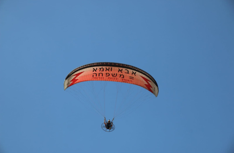 Tnuat Hazon's paraglider with sign opposing Tel Aviv Pride Parade. (photo credit: TNUAT HAZON)