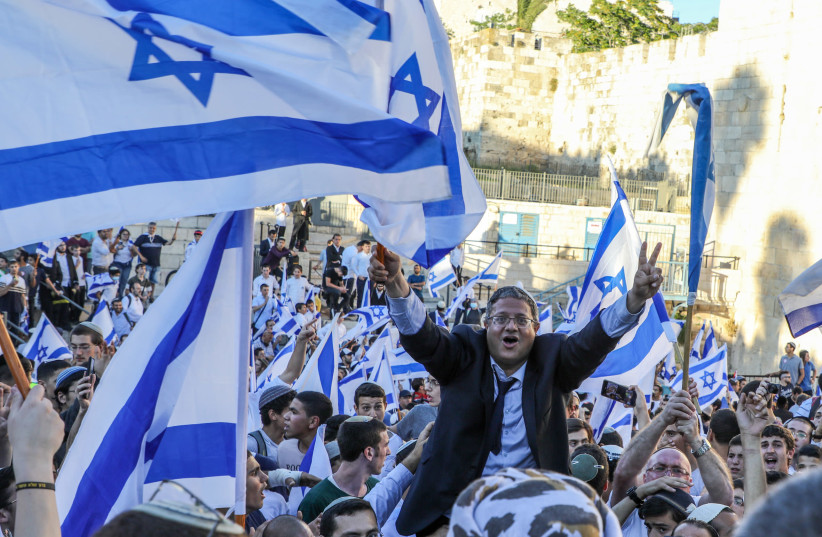 Itamar Ben-Gvir waves a flag at the Jerusalem Flag March on June 15 (credit: MARC ISRAEL SELLEM)