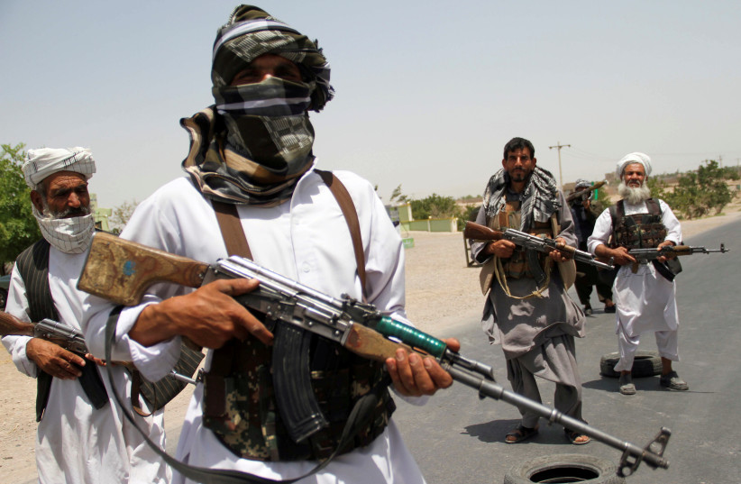 Former Mujahideen hold weapons to support Afghan forces in their fight against Taliban, on the outskirts of Herat province, Afghanistan July 10, 2021. (credit: JALIL AHMAD/REUTERS)