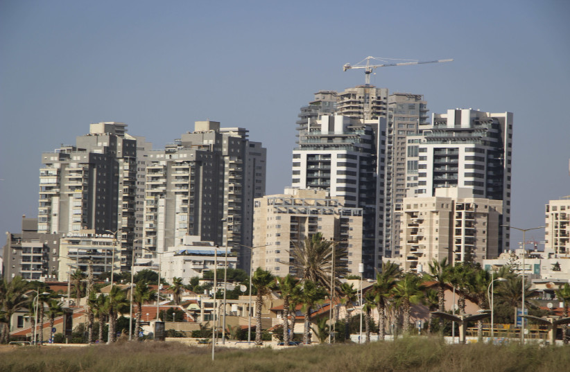 View of new high-rise apartment buildings next to older small homes, in the southern Israeli city of Ashdod (credit: GERSHON ELINSON/FLASH90)
