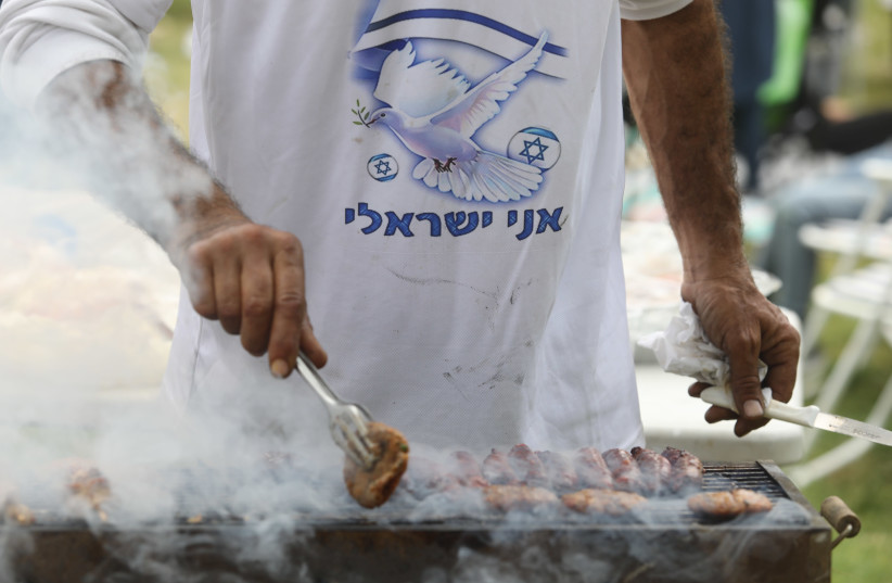 A man barbecues meat on Independence Day in Jerusalem. (photo credit: MARC ISRAEL SELLEM)