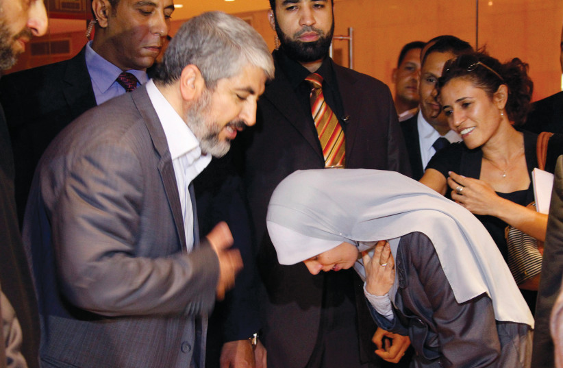  Sbarro terror mastermind Ahlam Tamimi prays with Hamas leader Khaled Mashaal, Cairo 2011 (credit: JAMAL SAIDI/ REUTERS)